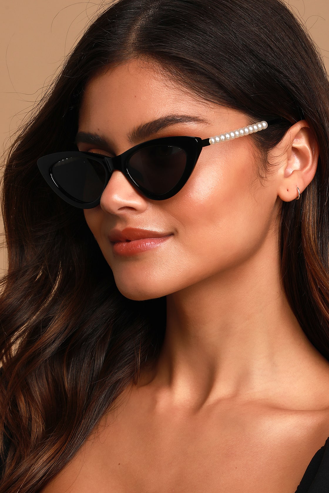 These chic cat-eye sunglasses with tinted black lenses and elegant black frames.