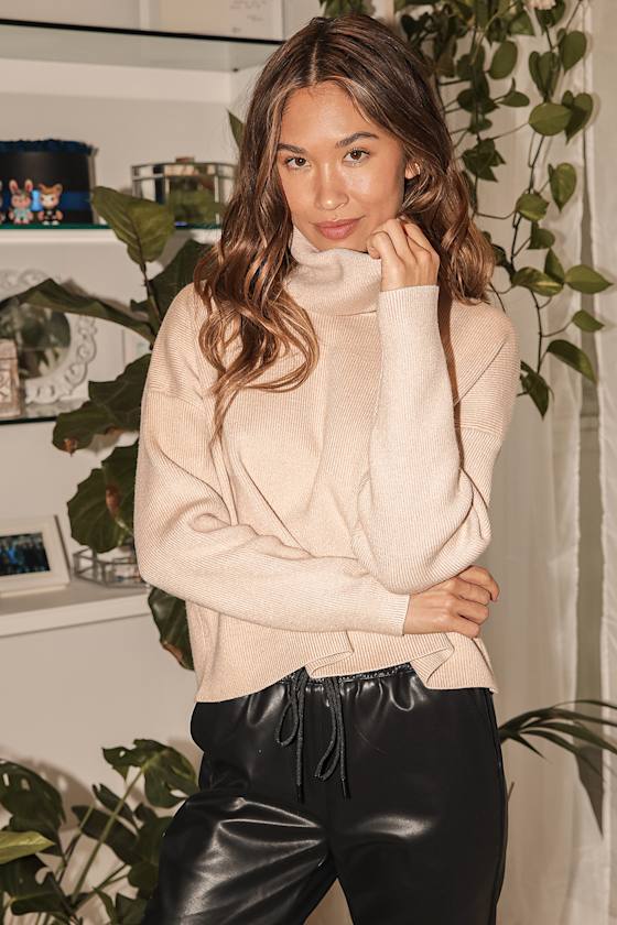 Beige cowl-neck sweater with a softly folded opening.