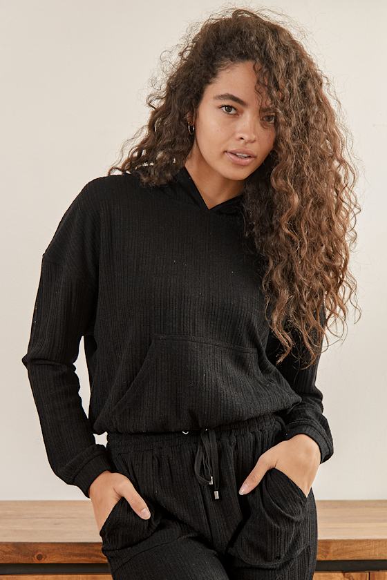 Black hooded pullover in a knitted fabric.