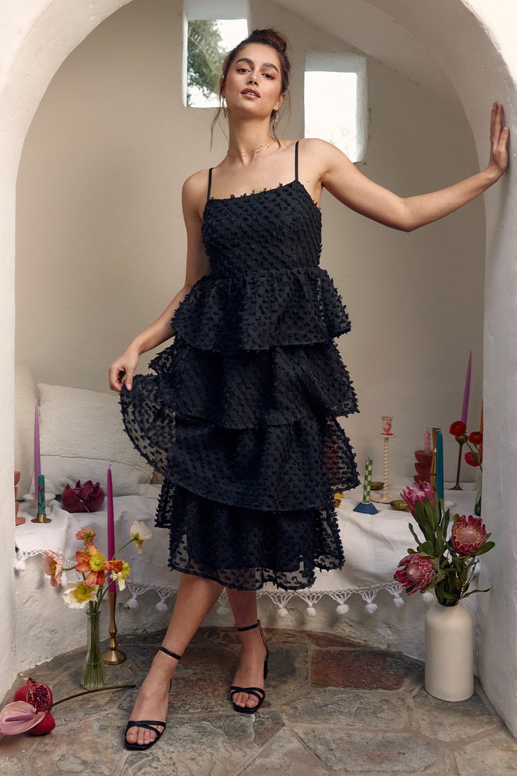 black dress with pom poms