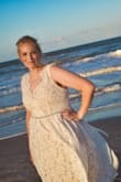 I ordered this dress for my summer beach wedding. I originally ordered a large but ended up contacting customer service the next day and asked for an XL( it happened to be the last XL in stock). The liner of the dress made me feel like I looked bigger so I bought a bridal belt to accentuate my hips/ give the dress a little something extra. I absolutely loved the built in pockets. Overall I was very happy with my decision to purchase my dress from Lulus. The customer service department was easy to work with and the quality of the dress is amazing. Absolutely love this dress! - Heather S.