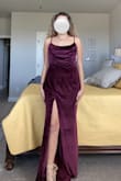 More so on the purple side than red as pictured. A lot of material where the cowl is, almost too much. Loose on the body but not loose enough to size down, very awkward. Even though I ordered other dresses in this exact size and never had an issue. - Caitlin O.
