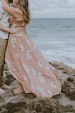 I originally got a L and had to exchange it for an XL, because it wouldn't wrap correctly. This was definitely a better fit, although the straps were a little bit big. I wore it to our engagement photos and it photographs beautifully! I did have to use a little fashion tape to keep the top from being too revealing and for the fabric not to flip outward. It's definitely too long but for the photos I didn't mind. My cat ate one of the straps to tie it so I had to tie it in the back. - Rebeca M.