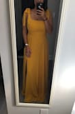 I absolutely adore this dress! If you have a moderate to large chest, size up! Unfortunately due to the snug chest area with no stretch at all, I had to size up to a large. I have to get the length of the dress tailored but I think it'll be worth it. - Maya A.