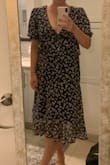 This dress is so cute! The sizing is true to size, I normally wear a medium in dresses (5'9", 160lb) and the medium fit great. There's a little wiggle room in the midsection which was helpful for sizing. The low cut is also super flattering for my smaller chest. My only issue with the dress is the elastic in the sleeves is super tight so it digs in a little. The fabric at the bust also turns out a little bit instead of laying flat at the seam, but not too noticeable and fashion tape would easily fix that. It's also hard to tell in the photo, but the tie in the front is part of a small peplum layer. Wasn't an issue for me, just didn't realize it was there from the photos. This dress is just too cute! - Abbey M.