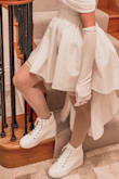 Wanted a pair of high top white sneakers and the platform heel of these was a bonus. I LOVE these shoes and even bought my sister some for Christmas. I wear a size 9 and these fit perfectly but somehow also made my feet look more petite than my Nikes. - Emily M.