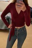 I love the soft material, the beautiful red color, and the fit of this shirt. It is quite cropped, and I don't have high-waisted pants that are high enough to come to meet the bottom of the shirt, so it shows a bit more midriff (and belly button) than I usually like to personally, but I'm getting used to it. The tie is pretty long, and you definitely feel the knot against your side, but after I wear it for a bit, I stop noticing it. Overall, though I love it! - Jenna K.