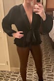 This top is so pretty! The neckline plunges but isn't too revealing- I slapped some double-sided tape on and it was perfect. Like other reviews, the material is stiff but it's still flowy and comfortable and looks great with leggings and heels! - Amy B.