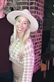 I ordered this hat hoping it would be more of an ivory/white color but it leans more tan than white. It also has a black ribbon inside that I think is noticeable with my blonde hair. Prob wouldn't be as noticeable for someone with darker hair. Overall it's just ok. - Blair B.