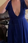 The dress is a few inches lower cut than pictured. The v neck was all the way to my stomach and wide. - Catherine M.