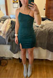 I own both XS and S dresses from Lulus, so I bought this one in both the XS and S to try. The XS was pretty tight, but the material is very stretchy and comfortable. It is not super thick, but definitely not flimsy as it is lined. A good middle ground. When I tried on the S, I knew the tightness of the XS was actually a major benefit. The S was way too big on my waist and upper body, which caused the dress to ride up and nearly expose my entire butt. The XS is tight enough to keep the dress in place and also to not have to wear a bra. I like the neckline a lot but could see how others might be off-put by the asymmetry. The straps are a very stretchy elastic material, just FYI. While the skirt is a little tight on my hips as I have some booty, the skirt on the S did not look much different. I love the deep emerald green color and am excited to wear this out and about for my bday! - Stephanie S.