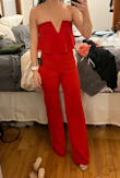This jumpsuit is an amazing addition to the wardrobe! The material is incredibly stretchy, making it fit like a glove all over. Extremely flattering on the butt, hips, legs, etc. I have a very small chest, but think it still looks good on the top. The V in front is pretty deep, so wearing a bra is hard with this, even a plunge front, but not impossible. I am 5'5 and even with 3" heels on I will likely need to have it hemmed an inch or two. I also tried on the size Small as jumpsuits can fit too tight on my torso sometimes, but found it to fit exactly the same way as an XS only more fabric up top and in the crotch. So if you're taller than 5'5 or have a super long torso, going up to S might be better for you if you have similar measurements to me. - Stephanie S.
