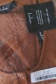 The name of the color upon receiving the dress is actually called "copper," which is more accurate than the "rust brown" listed as part of the description. This dress is actually a medium brown shade. I think the lighting used while taking the photographs gave it more of a warmer orange tone, which simply does not exist in the actual garment. The snaps were not sewn in a straight line, so the dress will never fit quite right. Aside from those two major things, the dress matches the description. - Kristina H.