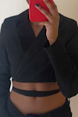 I was initially worried where it would fall because I have a short torso and narrow shoulders but it looks really cute. It falls about an inch and a half above my belly button. The shoulders don't look oversize and I really like that there's a little bit of padding in them. Depending on how comfortable you are you might not want to wear a bra underneath because if you lift your arms up you can see it. The sleeves are also the perfect length! - Elise R.