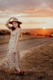 I also wore this for my engagement shoot and am over the moon with it. I did hem the dress some for reference. I didn't find the dress to shift much like other reviewers mentioned as long as you pulled the strings tight and got a tight knot in it the first time. So many compliments on this and feel amazing in it! - Caia B.