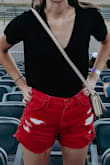 This bodysuit isn't too short for me, and the material is super comfortable. The fit is a little looser, but that's what I wanted from a t-shirt style. - Hannah A.