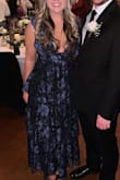 This was such a great dress to wear to my friend's wedding! I got so many compliments on it and it was very comfortable to wear all night. The fit was a little larger so it was a good fit for my chest. I used tape to secure myself and the neckline looked great with this option. It dips low so you'd have to have a specific type of bra with it. - Lindsay M.