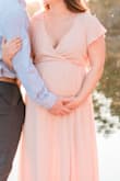 I wore this dress for my maternity shoot. It does run large so I could have stuck with a S but went with a M because I am currently 180lbs and everything has been super tight. My chest is currently a D cup and I still think the S would have fit. - Stephanie B.