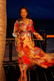 It's a beautiful dress. It is perfect for a resort getaway as well as a wedding reception. The color is bright and vibrant and the dress overall is very flattering. However, if you are large chested like me you might wanna size up. I got a hook stitched in and it stayed in place all night. - Srijita D.