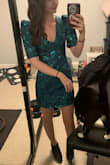 I weigh 105- I usually order XS, but read reviews and got a small. It was a tiny bit loose on me, making the V too deep, but I was able to pin it at the shoulder seams and it looked fantastic. Sleeves are puffier than in pictures. Short dress and looks amazing with black booties! The color is teal/turquoise not green. - Erin O.