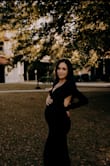 I bought this for my maternity pictures & it fit like a glove! Thankfully the material is stretchy and it was able to fit over my bump. I usually wear a size small but ordered a size up to use for maternity. This dress is so beautiful & classy. - Courtney H.
