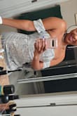 This dress fits perfectly in the body. Did feel a little tight in the armbands but it was not an uncomfortable tight. Will definitely be wearing it to another event!! - Aurora F.