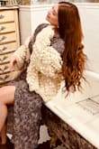 I bought the sweater and the dress the model is wearing. Absolutely loved both!! Received a million compliments. - Hannah J.