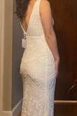 I would definitely order a smaller size than usual, I usually order a medium but the small fit perfectly. The deep v wasn't as revealing as I had expected. Very nice details but a little too sparkly for me. - Lydia C.