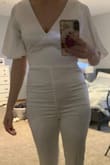 I realllllly wanted this to fit me. It's beautiful and the material is so comfortable. My problem is I have a smaller chest (34B), but wider hips (39") so in clothes with no stretch, it's hard to make it work. I could easily zip it up, but the lower half was too tight. I feel like if I sat, it had the potential to rip very easily. It also bunched up for me in the front (see picture). The top half fit perfectly, so I know if I ordered a medium it would just be too big up top. I ordered a small one and will be returning it. - Whitney S.