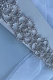 The material is very strong (meaning it doesn't seem to break easily) and it's elegant looking. I cannot wait to try this on with my dress! It comes with a long ribbon which you can adjust to your size. I would recommend this to anyone who is looking to enhance the look of their dress! - Yana B.