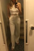 Love this top! It's a little too loose to wear without a bra so I might need to find an adhesive bra or something. But the material is great, it's thick so not see-through. I got it to wear with the white high-waisted beach pants from Lulus. - Caitlin C.