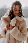 This coat my my wedding day all the more special. I had originally not planned to have a fur coat and one week before I changed my mind and ordered this coat with little knowledge of Lulus and their products. I was very surprised but the fast service and wonderful product. This coat made a beautiful additional to some of my wedding photos. Thank you, Lulus for the amazing find! - Kayla A.