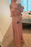 This is a well made and beautiful dress. I am returning this dress because there is not enough coverage through the chest. I am "apple" shaped. The dress fit around my middle; the side seams lined up with the middle of my body. However, it felt way too small around the top. The dress comes with a snap closure the bust region. I am not sure who on earth would be able to use that snap. It is clear that even the model in the photos is not using the snap closure at the bust. If you have a medium or larger chest/bust, you might be able to relocate the snap or sew-tack the chest, or have to be comfortable with a very revealing neckline. Also, the length was floor length when I was NOT wearing heels. Keep this in mind taller folks. - Adriana C.