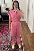I have a long torso and short legs for my height, but there was ample room in the crotch as well as a slightly longer pant length that I can roll up or pair with taller shoes. I'd say if you're much taller than I am the legs may be short on you. This jumpsuit has a bit more of a relaxed fit, but the buttons on the side can bring in the waist to define your shape. The color is a muted salmon-meets-bubble gum color. This is such a fun piece, I can't wait to wear it all the time. Please excuse my socks in my photo :p - Annie S.