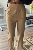 The material is thin so the lining of the pockets is visible and unflattering in the khaki color. Much less noticeable with the black pants. I'm not wowed by the fit but they might be too tight if I go a size down. I'll be returning the khaki pant. - Marie H.