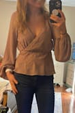 LOVE this top. The color is perfect for any season! The top doesn't have much stretch if at all so if you are between sizes like I am order up! - Jena S.