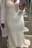 I sized down so that my dress would be more fitted than the model's, and it fits perfectly. The material is stretchy and comfortable. The arms are a bit longer than I like, but that's an easy fix. The dress is very simple, smooth, and beautiful. - Mary W.