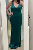 The dress is a beautiful color and nice thick fabric that does have a stretch to it. It fits very nicely and I can even wear a regular bra with it which is a big plus for a girl with a larger bust! The only downside is that it's super long and will need to be hemmed. I bought a large and am 5'5, 138lbs, 34E and typically wear a medium or size 8. - Kathryn M.