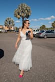 Cute dress, has great movement, very lightweight. Definitely see through so requires nip covers as well as skin toned underwear. Does run slightly larger, I'd be afraid a full size down might be too small though. The waist strap made it seem more fitted though. - Alicia R.