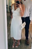 The fit is weird but I had it altered to my size. It is a true to size fit WITH stretch, I usually am a size small but ordered one size larger incase the satin didn't stretch but should of kept a S. The length hit me at mid calf unlike the model and the slit up the leg is super high. Otherwise, I loved this midi. Paired with heels from here - Taylor P.