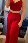 I got this for graduation and when I tried It on, I thought I would need something under but the top fit great. I was able to tighten it and ended up not needed something under it. The bottoms also fit pretty well but out of the package, the material was VERY staticky and when I put it on, it picked up a lot of dust around my house. Other than that, the material was pretty soft and pretty good quality. Good outfit overall, just needs a little steam on the bottoms. - Karina G.