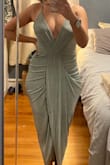 This dress fits like a glove & is super flattering. The surpluses style doesn't bulge too much in the front. There are tightening straps in the back also which is nice. - Jennie R.