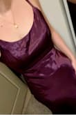 The material is amazing. Wine/purple with almost a holographic shine in the light. The fabric at the seams and zipper does bulge/stick out but that may resolve itself after the dress is steamed. I'm 5'6 and with 3 inch heels I don't think it will need to be hemmed. The adjustable straps are great too. Overall a classic dress to have in your closet - Caroline D.