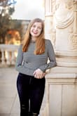 This top is one of my favorite tops! It is tight fitting but stretchy material! Love it soooo much - Morgan W.