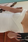 I decided I needed to get an after-party dress for my wedding, as we are going downtown to the bars and the logistics of a full wedding dress in bar bathrooms was terrifying! Lol. Very flattering! Nice thick material. Others have mentioned "wings" in the back... I get that and will be sewing the back parts down to try to help with it. 
I was initially thinking I could go braless (small 36D) but I could see a bit of nipple shape through and would have preferred a tad more support (I'm almost 40 so younger women may not feel this way) so decided to wear with a strapless which feels nice and secure in the dress.
I have very wide hips/full butt (approx 44 inches at widest part) and the medium fits well, comfortably snug, not tight. 
Can't beat the price! Looks similar to dresses I've seen at David's Bridal and BHLDN but at least half the price! Give it a try! Can't lose as Lulus has a great return policy, order 2 sizes if ya need to just to be sure and return the other! - JUDITH E.