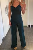 I loved this jumpsuit! I wore to a friend's rehearsal dinner and received a ton of compliments. I ordered both the small and x-small, the small was more flattering and comfortable. A little long might hem for future wear but heels solved the problem. Buy it! Lovely jumpsuit. - Sarah H.