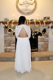 The dress was so beautiful and perfect for our small wedding ceremony. I received a lot of compliments. Being petite, I wasn't expecting it to fit perfectly. I had to get the dress hemmed and add another clip on the top piece of the dress so it wasn't too loose. I would definitely recommend this dress! - Destiney V.