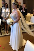 I ordered 7 gowns from online and tried on 9 in stores. And this gown was perfect for our Las Vegas wedding in December.  It was stunning but had to get it tailored down which was more than the dress cost .  I added the custom cape .  I got so many compliments on the dress.  I'm 54 years old , 1st marriage. I will be tailoring the dress again to the knee to used a cocktail dress in the future. - Kelly V.