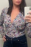 I love this top for the print and the style of it. It's not a drastic puffy sleeve but it's enough that makes it feel dressier. The fabric is pretty thin. My only complaint is that I can't understand for the life of me why tops that are meant to be tucked in, as advertised (and this isn't just Lulus), are awkwardly cropped. I lift my arm only a tiny bit and the shirt pops out of my pants where it's tucked. I can't sit without it popping out either. For this reason, I might be returning, which is upsetting. - Brittney J.