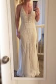 As soon as I put this dress on I *knew* it was the one. Even taking it out of the packaging I was so impressed and excited. The beading is absolutely beautiful and of great quality. The placement is so flattering. I'm in love. The straps are adjustable and maybe a little on the thin side. It has a simple tan lining which I love. I will need to have it hemmed a few inches but I am 5'5 and plan to wear flat shoes. If you're considering this dress - BUY IT! You can always return it if you don't like it. ;) - Lindsey B.